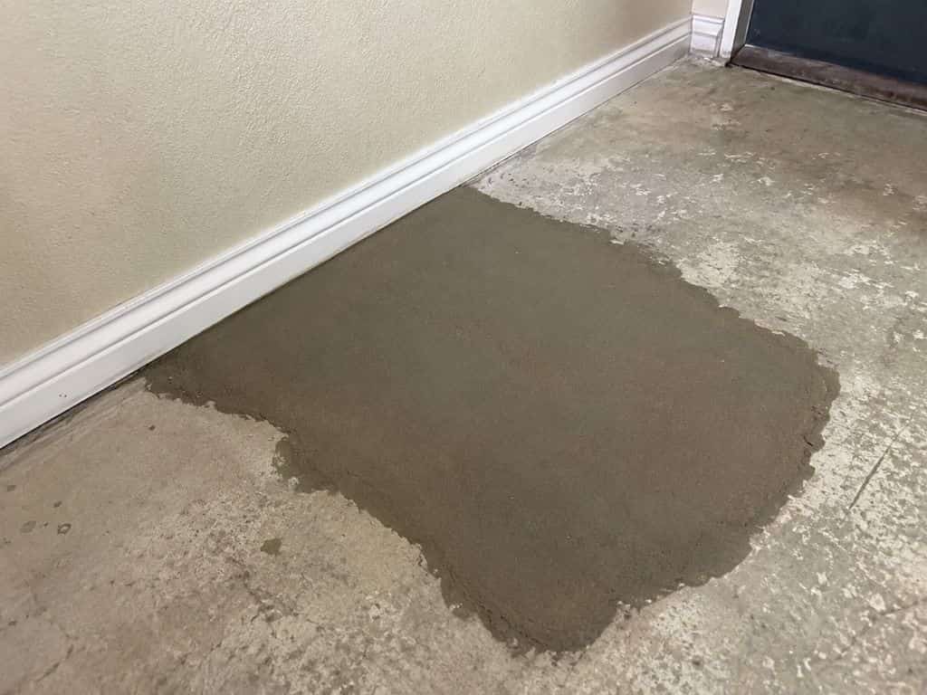 Fresh concrete patch covering a completed slab leak repair inside a home in Sherman Oaks, CA.